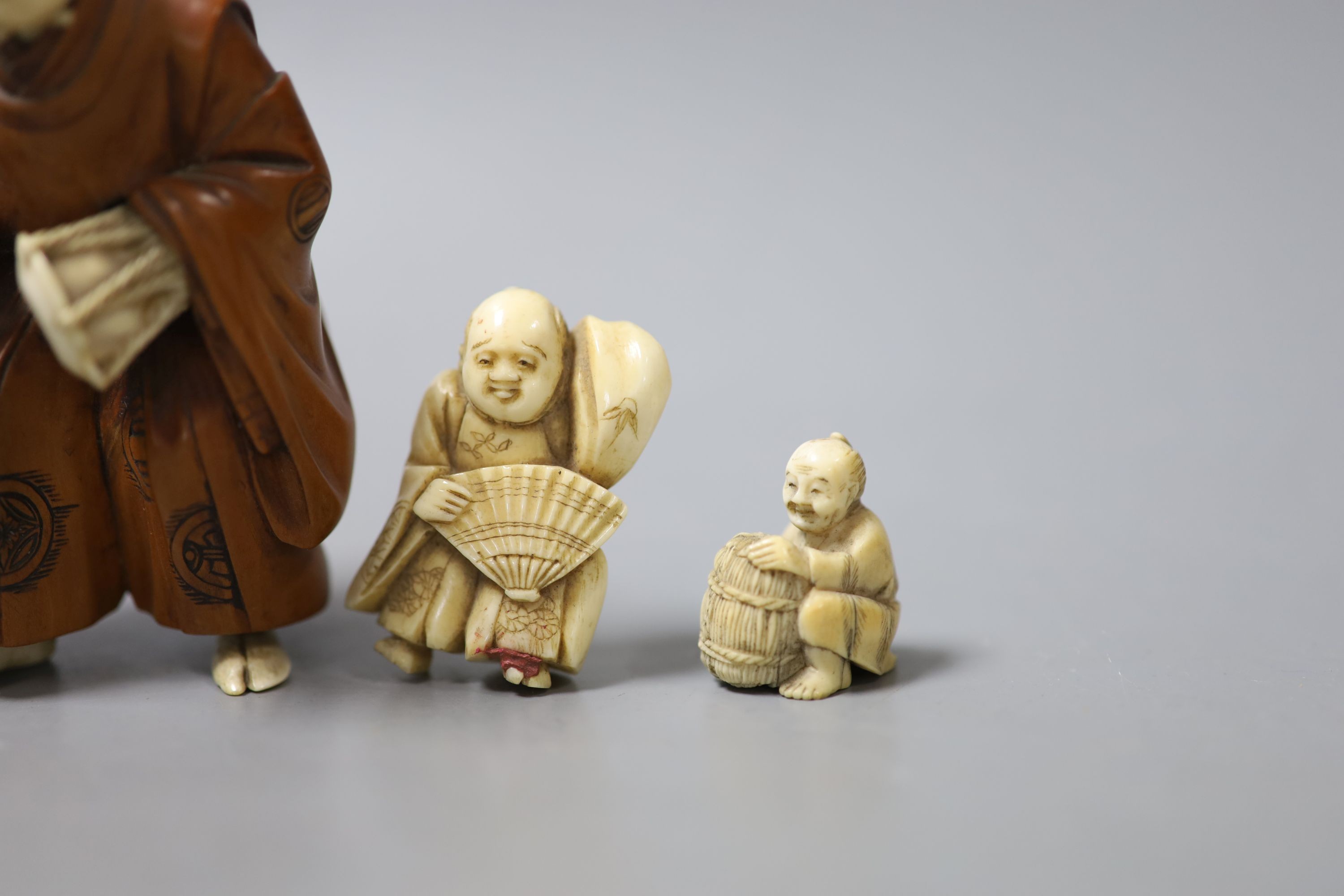 Three Japanese ivory netsuke, a similar okimono and a boxwood and ivory okimono, 9cm (losses)